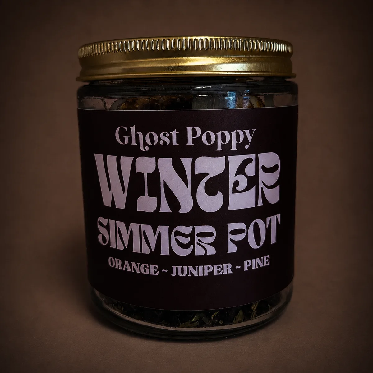 Simmer pots — Ghost Poppy Winter Simmer Pot jar, orange, juniper, and pine, on a warm brown surface