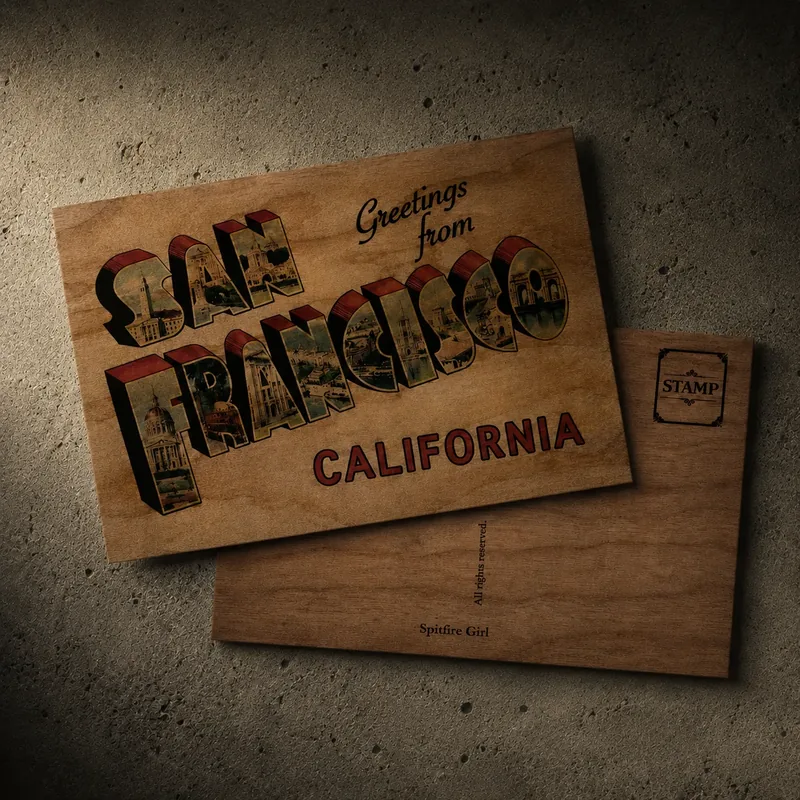 Wooden postcard — a vintage 'Greetings from San Francisco California' large-letter postcard printed on real wood, shown front and back with a stamp box, on a concrete surface